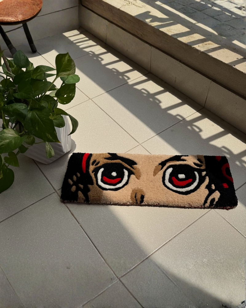 Decorative rug with cartoonish face design on a tiled floor